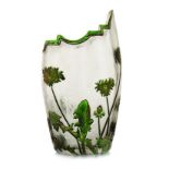 A DAUM NANCY ASYMETRICAL GLASS VASE, 1920’s decorated with green and gold flowers and leaves against