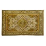 A TABRIZ RUG, NORTH WEST PERSIA, MODERN the ivory field with a pale green floral medallion, brown