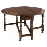 AN OAK GATE-LEG TABLE, 19TH CENTURY the rectangular top with hinged drop sides, above a frieze