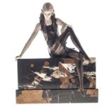 AN ART NOUVEAU STYLE PAINTED BRONZE FIGURE OF A SEATED WOMAN depicted wearing a pleated dress and