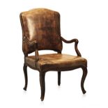 A FRENCH MAHOGANY AND UPHOLSTERED FAUTEUIL, 19TH CENTURY the close nailed padded back and seat