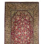 A KESHAN CARPET, PERSIA, MODERN the burgundy red field with an overall design of multi-coloured