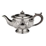 A VICTORIAN SILVER TEAPOT, THOMAS RUSSELL & CO, SHEFFIELD, 1900 the compressed circular chased