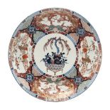 A JAPANESE IMARI CHARGER, MEIJI, 1868-1912 the centre painted with a pomegranate-filled basket