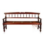 A CAPE STINKWOOD REGENCY BENCH the shaped top and plain mid-rail joined by turned spindles,