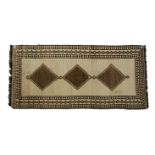 A GABBEH RUG, PERSIA, MODERN the plain ivory field with three brown diamond medallions within an