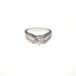 A DIAMOND RING centred with a round brilliant-cut diamond weighing approximately 1.16cts, the