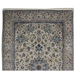 A NAIN CARPET, PERSIA, MODERN the ivory field with a blue floral star medallion, all with multi-