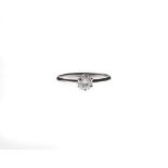 A SOLITAIRE DIAMOND RING centred with a claw-set round brilliant-cut diamond weighing