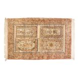 A QUM SILK RUG, PERSIA, MODERN the field divided into four panels, each containing a complete rug