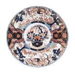 A JAPANESE IMARI CHARGER, MEIJI, 1868-1912 the centre painted with a flower-filled jardinière