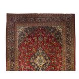 A MESHED CARPET, EAST PERSIA, MODERN the burgundy red field with a dark indigo-blue and ivory floral