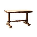 A VICTORIAN ROSEWOOD WRITING TABLE the rectangular top above a plain frieze, on shaped stile