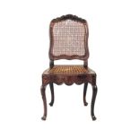 A CAPE STINKWOOD AND CANED CHAIR, 19TH CENTURY the panelled back above a square caned seat, shaped