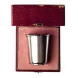 A CASED PORTUGUESE SILVER BEAKER the tapering cylindrical body with satin matt texture, gilt