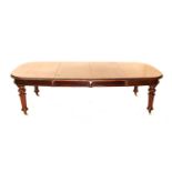 A VICTORIAN MAHOGANY EXTENDING DINING TABLE each D- end above a plain frieze, on turned fluted legs,