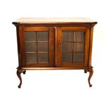 A CAPE STINKWOOD DISPLAY CABINET, 19TH CENTURY the rectangular plain top above two glazed panel