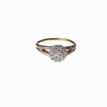 A DIAMOND DRESS RING designed as a raised button pave set with round brilliant-cut diamonds, the