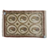 A QUM SILK RUG, PERSIA, MODERN the ivory field with six floral medallions each containing one "