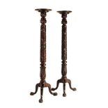 A PAIR OF OAK GUERIDONS the turned dish with a rim above foliate-carved column, on three