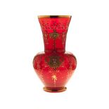 A VENETIAN ENAMELLED AND GILDED CRANBERRY GLASS VASE the tapering ovoid body with trumpet neck,