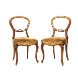A PAIR OF MAHOGANY BUSTLE BACK CHAIRS, 19TH CENTURY each curved shaped top-rail above a carved and