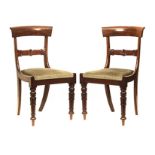 A SET OF EIGHT REGENCY STYLE MAHOGANY DINING CHAIRS each curved shaped top-rail above a foliate