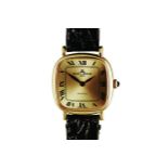 A GOLD-PLATED WRISTWATCH, BAUME ET MERCIER BAUMATIC manual, the rectangular cushion-shaped gilt dial