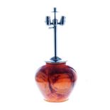 A WMF IKORA GLASS LAMP, 1930’s the ovoid body of orange with dark russet and gilt inclusions,