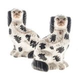 A PAIR OF STAFFORDSHIRE BLACK AND WHITE SPANIELS, 19TH CENTURY each seated, wearing a gilt collar