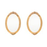 A PAIR OF GILTWOOD MIRRORS, 20TH CENTURY each oval beveled plate within a beaded surround, the frame