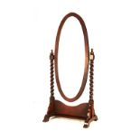 A TEAK CHEVAL MIRROR, 19TH CENTURY the oval shaped plate within a conforming frame, suspended