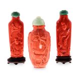 A PAIR OF CHINESE CARVED CORAL SNUFF BOTTLES AND COVERS each of flattened cylindrical form, carved