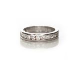 A DIAMOND HALF-ETERNITY RING the plain band channel set to the centre with brilliant-cut diamonds