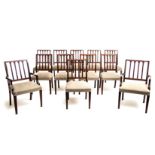 A SET OF TWELVE SHERATON STYLE MAHOGANY DINING CHAIRS comprising: a pair of carvers and ten side