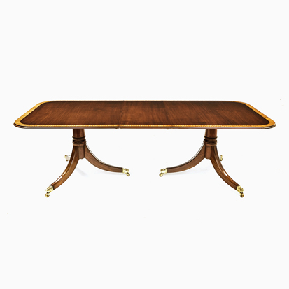 A REGENCY STYLE MAHOGANY EXTENDING DINING TABLE RETAILED BY JOHN PLUMMER, LONDON each rectangular