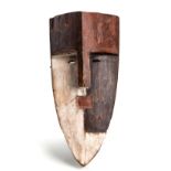 A POLYCHROME FANG MASK the mask carved with angular forehead, slit eyes, square mouth and pointed