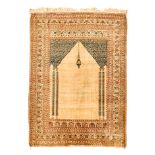 A TABRIZ PRAYER RUG, NORTH WEST PERSIA, CIRCA 1900 the plain mehrab with twin columns and a