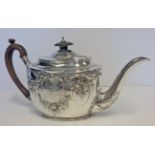 A GEORGE III SILVER TEAPOT, MAKER’S MARK IB, LONDON, 1806 the oval body with C-scrolls, flowerheads,