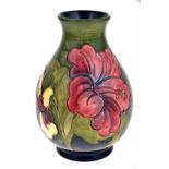 A WALTER MOORCROFT 'HIBISCUS' PATTERN VASE, 1940s of tapering ovoid form, shaded blue and green