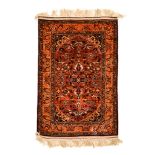 AN INDO-PERSIAN SILK RUG, MODERN the rose field with a floral skeleton medallion, dark blue
