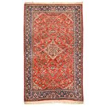 AN ISPAHAN CARPET, PERSIA, CIRCA 1970 the red field with a pale rose floral diamond medallion, all