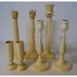 A PAIR OF IVORY CANDLESTICKS NOT SUITABLE FOR EXPORT of baluster form raised on a circular base, the