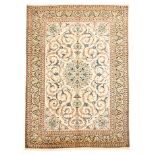 A KESHAN CARPET, PERSIA, MODERN the ivory field with a pale blue floral medallion and pendant,