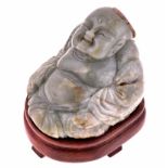 A CHINESE JADE CARVING OF A BUDDHA, LATE 19TH/EARLY 20TH CENTURY the figure seated cross-legged