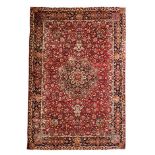 A MESHED CARPET, EAST PERSIA, MODERN the burgundy-red field with a blue-and-ivory floral star