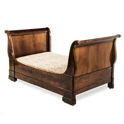 A BIEDERMEIER FLAME MAHOGANY LIT EN BATEAU, 19TH CENTURY the shaped panelled headboard and