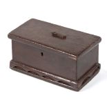 A PINE PAINTED MONEY BOX, CIRCA 1900 the rectangular hinged cover with central aperture and swivel