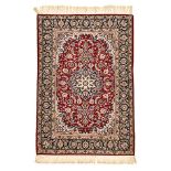 AN ISPAHAN RUG, PERSIA, MODERN the red field with a dark blue floral star medallion, ivory