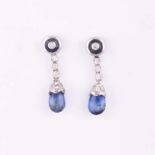 A PAIR OF SAPPHIRE AND DIAMOND PENDANT EARRINGS each surmount centred with a circular cabochon